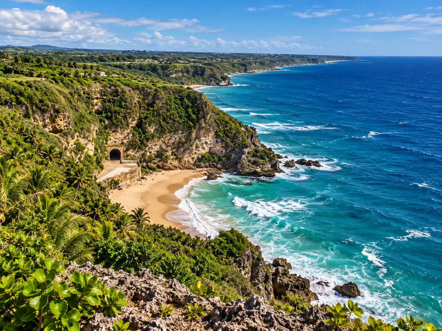 Daytime panorama of the Quebradillas coastline with sandy beach, cliffs, and turquoise ocean