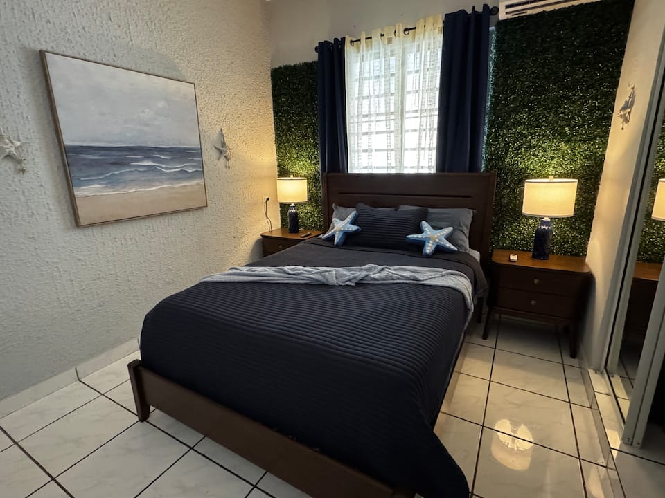 Queen bedroom with coastal art